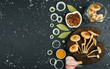 © Виктория Саврей - Fresh mushrooms with spices and herbs on black board. View from above. Copy space.