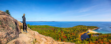 Female Hiker Standing On Ledge Enjoying View Of Water From Beehive Trail In Acadia National Park