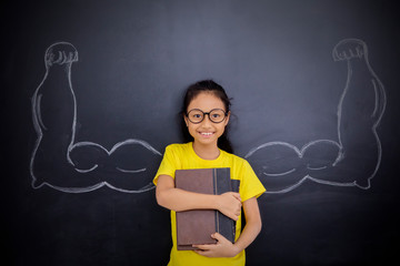 Wall Mural - Happy little girl showing her biceps