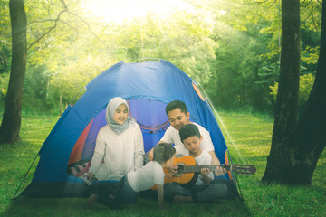 Wall Mural - Muslim family singing with a guitar in the tent