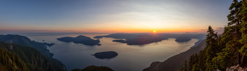 Wall Mural - Beautiful Panoramic View of Canadian Mountain Landscape covered in clouds during a vibrant summer sunset. Taken on top of St Mark's Summit, West Vancouver, British Columbia, Canada.