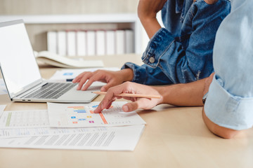 close up creative designer team brainstorming  in casual meeting on desk with laptop in meeting room at modern office with data sheet on table.business lifestyle concept.