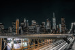 long exposure of traffic on Brooklyn Bridge with downtown Manhattan in view