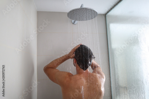 Man Taking A Shower Washing Hair Under Water Falling From