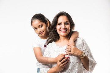 Wall Mural - Indian mother daughter on white background hugging, kissing, riding, flying, pointing, presenting over white background