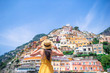 © travnikovstudio - Summer holiday in Italy. Young woman in Positano village on the background, Amalfi Coast, Italy
