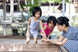 Leinwandbild Motiv Asian Little Chinese Girls and mother playing wirh duck