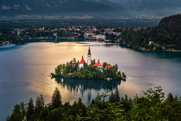 Wall Mural - Bled, Slovenia - Pilgrimage Church of the Assumption of Maria on an island at Lake Bled (Blejsko Jezero) and Julian Alps at background on a beautiful summer morning