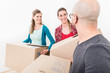 © Kzenon - Group of friends holding the cardboard boxes