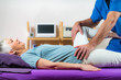 © Microgen - Physical Therapist Working with Leg. Senior Woman