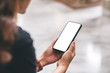 © Farknot Architect - Mockup image of a woman holding black mobile phone with blank desktop screen