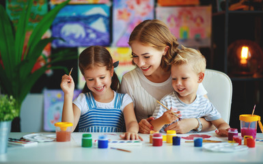 Wall Mural - mother and children son  and daughter painting draws in creativity in kindergarten.