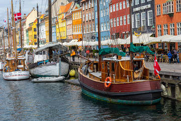 Wall Mural - Scenic summer view of Nyhavn pier with color buildings, ships, yachts and other boats in the Old Town of Copenhagen, Denmark.