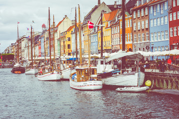 Wall Mural - Scenic summer view of Nyhavn pier with color buildings, ships, yachts and other boats in the Old Town of Copenhagen, Denmark.