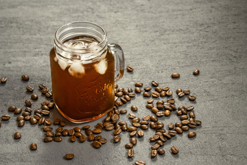 Iced filter coffee and coffee beans on isolated background