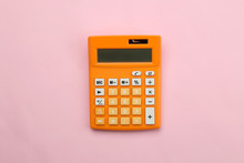 Orange Calculator On A Bright Paper Pink Background. Office Supplies. Education. Back To School. Top View.