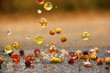 Glass balls in water. Water drops. Multicolored glass balls. Background