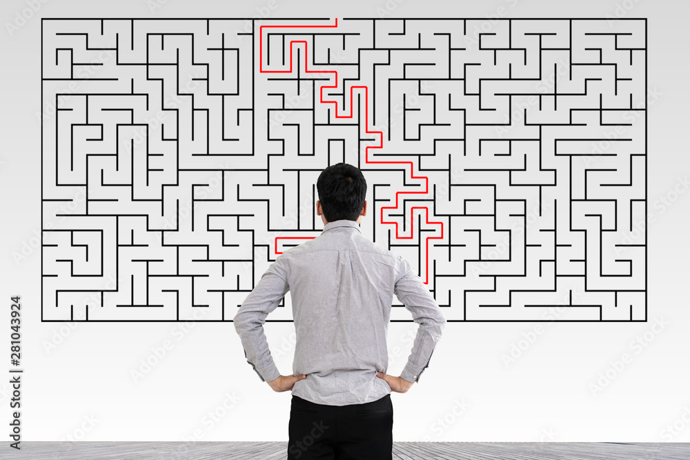 Businessman in doubt looking to a maze and searching the way out - obrazy, fototapety, plakaty 