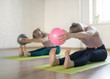 © junky_jess - Two caucasian girls doing stretching head to knees with small fit balls, in fitness studio, selective focus.