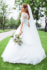 Wall Mural - beautiful bride in nature, portrait of a girl in a white dress