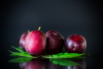 Canvas Print - organic red ripe cherry plum isolated on black