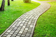 © Kirill Gorlov - Slab stone paved path way along green grass lawn at park or backyard. Walkway footpath road at house yard garden