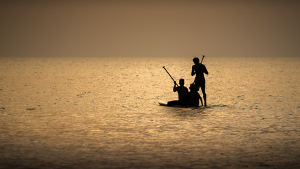 Wall Mural - The fisherman boat silhouette on the sea with sunset sky