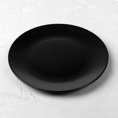 Poster - Black round plate on wooden background, top view, copy space