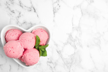 Delicious Pink Ice Cream Served With Mint In Heart Shaped Bowl On Marble Table, Top View. Space For Text