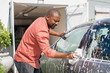 © Rido - Mature black man washing car