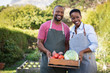 © Rido - African farmer couple holding vegetable crate