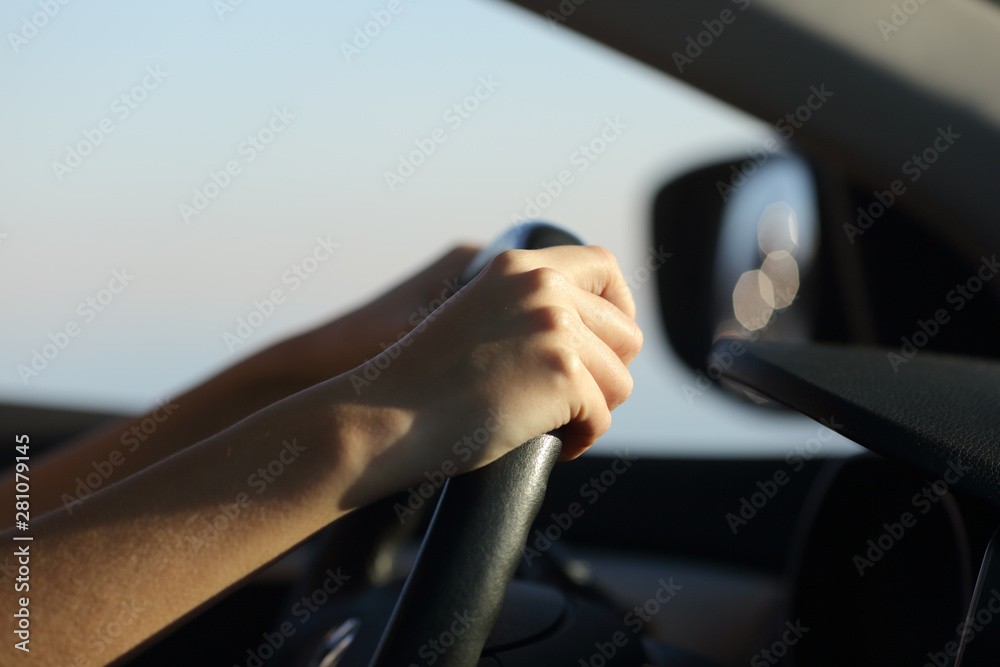 Driver hands holding steering wheel driving a car - obrazy, fototapety, plakaty 