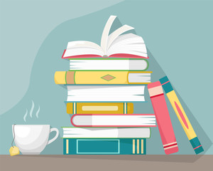 Stack of books with a cup of hot tea. Knowledge, learning and education concept design.