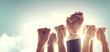 © oatawa - Hands of Business team raised fist air Corporate Celebration victory, success and winning concept. sunlight effect, copy space.