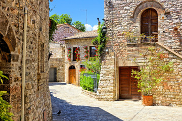 Wall Mural - Beautiful stone buildings of the flower filled old town of Assisi, Italy