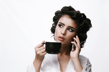 Wall Mural - Hot beverage. Woman funny happy girl holding a cup of tea or coffee. Beautiful girl speaks on phone 