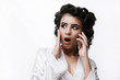 © Tetiana Moish - The girl is worried talking on the phone.  Morning preparation.  Girl in a bathrobe and curlers.