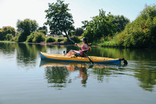 Young Woman Kayaking On River