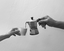 Cropped Photo Of Hands Pouring Coffee