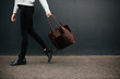 © Caleb Gaskins/Stocksy - Woman carrying bag