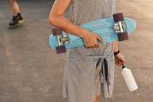Young Woman With Board In Skate Park