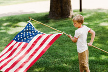 Boy Holding American Flag Outdoors