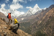 © Odyssey Stock/Stocksy - Hikers relaxing on rock against Himalayas