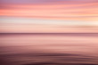 © Tim Booth Photography/Stocksy - A red and purple blurred seascape background