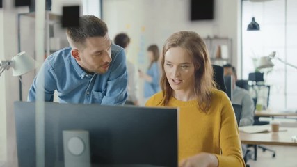 Poster - Female Specialist Works on Desktop Computer, Project Manager Stands Beside and gives Advice on Optimizing Workflow for Customer Experience Management. Modern Office with Diverse Team of Professionals