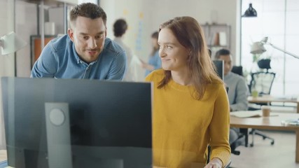 Poster - Female Specialist Works on Desktop Computer, Project Manager Stands Beside and gives Advice on Optimizing Workflow for Customer Experience Management. Modern Office with Diverse Team of Professionals