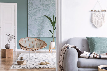 Boho style interior of apartment with rattan armchair and sofa