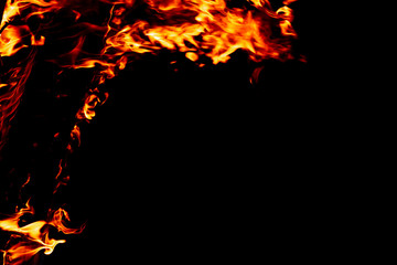 Fire on a dark background. Background from fire. Fire close up. Background for designers.Wood fire on black background