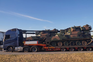 Over-standard, atypical road transport. A howitzer on the tank chassis.