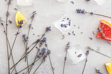 Lavender Flowers With Ice Cubes And Citrus Slices On Grey Background
